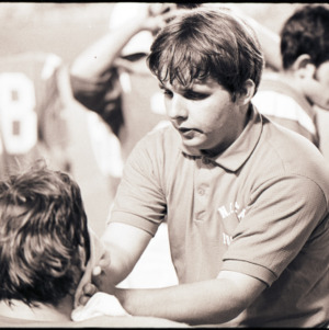 Football coach and players at NC State versus KSU game, circa 1969-1975