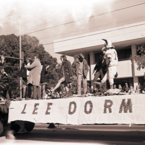 People and mascot on float in parade, 1969