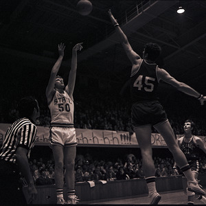 Basketball players and referee at NC State vs Atlantic Christian, circa 1969-1975