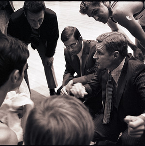 Basketball players around Norm Sloan at NC State vs. Atlantic Christian, circa 1969-1975