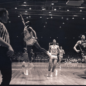 Basketball players and referee at NC State vs. Clemson, circa 1969