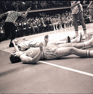 Basketball players and referee at NC State vs. Clemson, circa 1969-1975