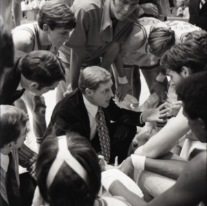 Coach Norm Sloan talking to team at NC State versus Duke basketball game, circa 1973-1974