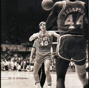 Basketball players and referee at NC State versus Duke game, circa 1972-1975