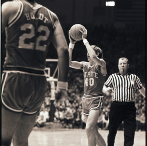 Basketball players and referee at NC State versus Duke game, circa 1972-1975