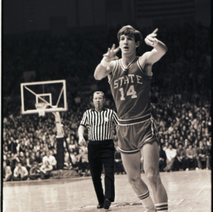 Basketball player and referee at NC State versus Duke game, circa 1972-1975