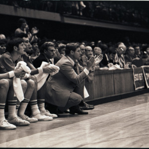 Basketball coach Norman Sloan and players at NC State versus East Carolina game, circa 1973-1974