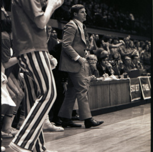 Basketball coach and spectators at NC State versus East Carolina game, circa 1972-1975