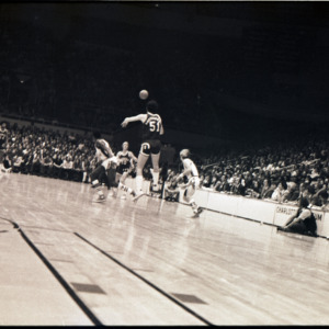Basketball players and spectators at NC State versus Furman game, circa 1972-1975