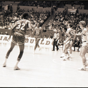 Basketball players and referee at NC State versus Georgia game, circa 1969-1975