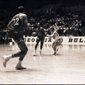 Basketball players and referee at NC State versus Georgia game, circa 1969-1975