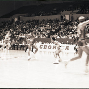 Basketball players and spectators at NC State versus Georgia game, circa 1969-1975