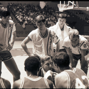 Basketball coaches and players at NC State versus Georgia game, circa 1972-1973