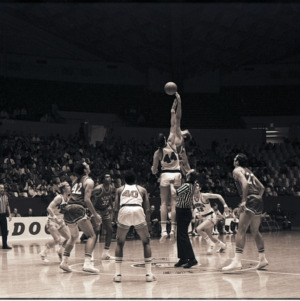 Basketball players and referees at NC State versus Georgia game, circa 1972-1973