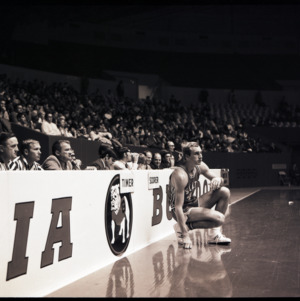 Basketball player, referees, and spectators at NC State versus Georgia, circa 1972-1973