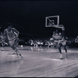 Basketball players and referee at NC State versus Maryland game, circa 1969
