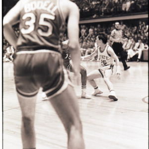 Basketball players and referee at NC State versus Maryland game, circa 1972