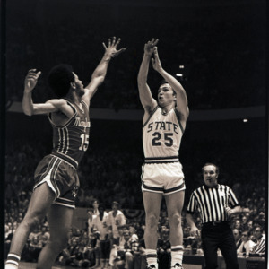 Basketball players and referee at NC State versus Maryland game, circa 1973-1974
