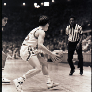 Basketball players and referee at NC State versus Maryland game, circa 1973-1974