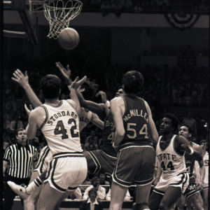 Basketball players and referee at NC State versus Maryland, circa 1973-1974