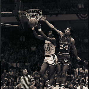Basketball players and referee at NC State versus Maryland, circa 1973-1974