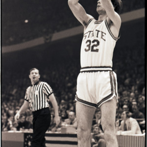 Basketball player and referee at NC State versus Maryland game, circa 1972-1975