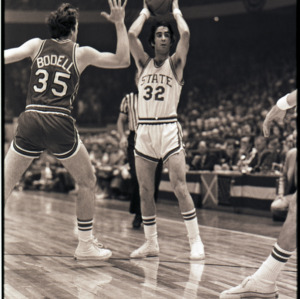 Basketball players and referee at NC State versus Maryland game, circa 1972-1975