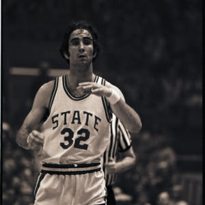 Basketball player and referee at NC State versus Maryland game, circa 1972-1975