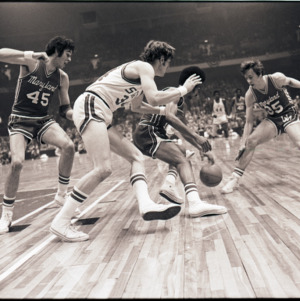 Basketball players and referee at NC State versus Maryland game, circa 1972-1975
