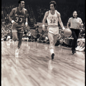 Basketball players and referee at NC State versus Maryland ACC title game, 1973