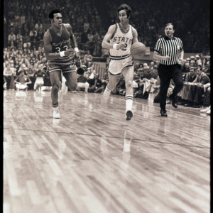 Basketball players and referee at NC State versus Maryland ACC title game, 1973