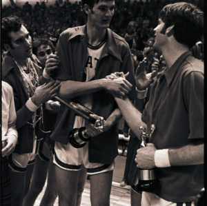 Basketball players with trophies at NC State versus Maryland ACC title game, 1973