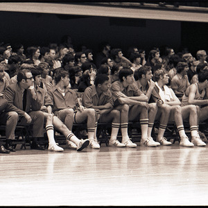 Basketball players, coaches, and spectators in stands at NC State versus Pittsburgh game, January 22, 1972
