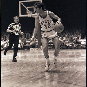 Basketball player and referee at NC State versus Pittsburgh game, March 16, 1974