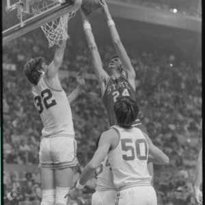 Tommy Burleson making basket at NC State versus UCLA basketball game, circa 1973-1974
