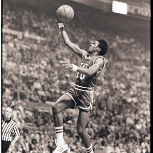 Basketball player and referee at NC State versus UCLA game, circa 1973-1974