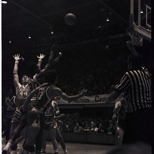 Basketball players and referee at NC State versus UNC-Chapel Hill game, circa 1971