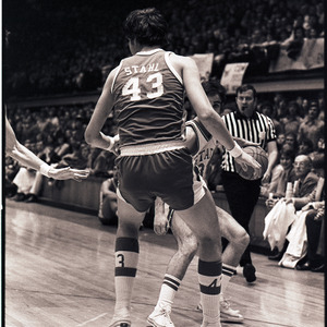 Basketball players and referee at NC State versus UNC-Chapel Hill game, circa 1971-1973
