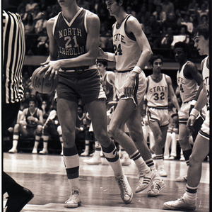 Basketball players and referee at NC State versus UNC-Chapel Hill game, circa 1973-1974