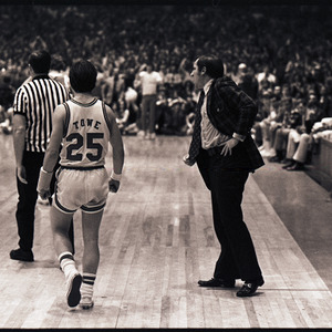 Basketball coach, players, and referee at NC State versus UNC-Chapel Hill game, circa 1973-1974