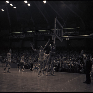 Basketball players and referee at NC State versus UNC-Chapel Hill game, circa 1969-1975