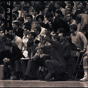 Basketball coaches, players, and spectators at NC State versus UNC-Chapel Hill game, circa 1969-1975