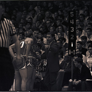 Basketball coaches, players, and referee at NC State versus UNC-Chapel Hill game, circa 1969-1975