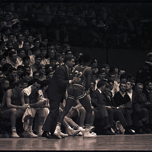 Basketball players and coach at NC State versus UNC-Chapel Hill game, circa 1969-1975