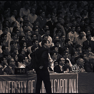 Basketball coach and spectators at NC State versus UNC-Chapel Hill game, circa 1969-1975