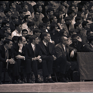Basketball coaches and spectators at NC State versus UNC-Chapel Hill game, circa 1969-1975