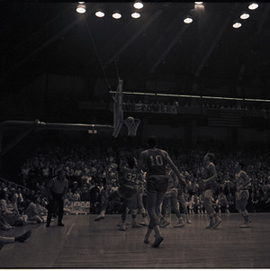 Basketball players and referee at NC State versus UNC-Chapel Hill game, circa 1969-1975