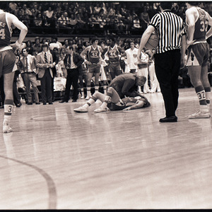 Basketball player getting first aid at NC State versus UNC-Chapel Hill game, circa 1969-1975