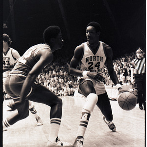 Basketball players and referee at NC State versus UNC-Chapel Hill game, circa 1972-1975