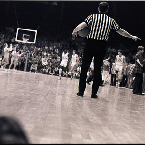 Basketball players, coaches, and referee at NC State versus UNC-Chapel Hill game, circa 1972-1975